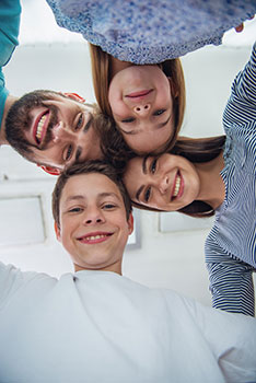 Selfie of a happy family of four with a mom, dad, son, and daughter