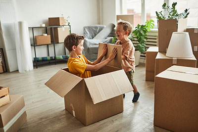 Kids playing with a box in their new home