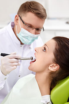 Woman getting a dental exam for no cost thanks to her dental insurance